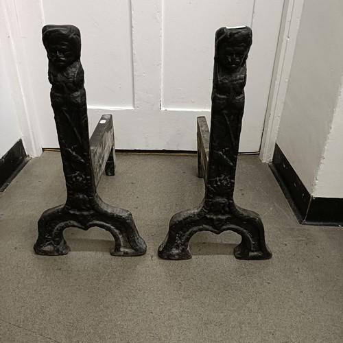 1322 - A pair of cast iron fire dogs, 54 cm high, a cast iron fire basket, 71 cm wide, a cast iron fire bac... 