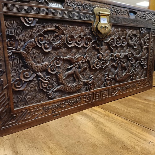 50 - A Chinese camphorwood trunk, decorated dragons, 104 cm