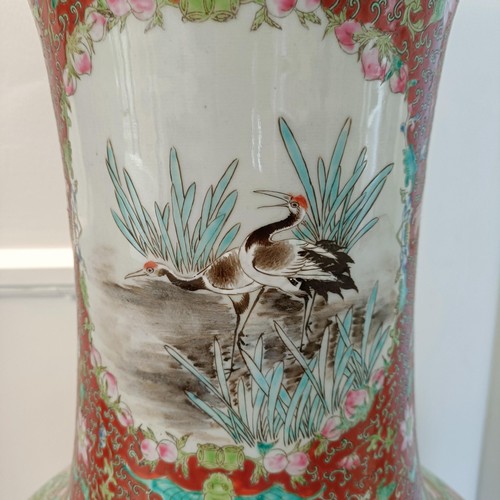 41 - A large pair of Chinese floor vases, of baluster form, decorated flowers and birds in enamel colours... 