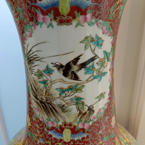 41 - A large pair of Chinese floor vases, of baluster form, decorated flowers and birds in enamel colours... 