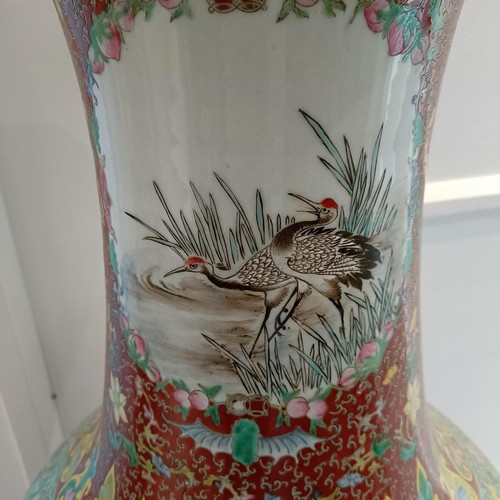 41 - A large pair of Chinese floor vases, of baluster form, decorated flowers and birds in enamel colours... 