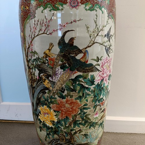 41 - A large pair of Chinese floor vases, of baluster form, decorated flowers and birds in enamel colours... 