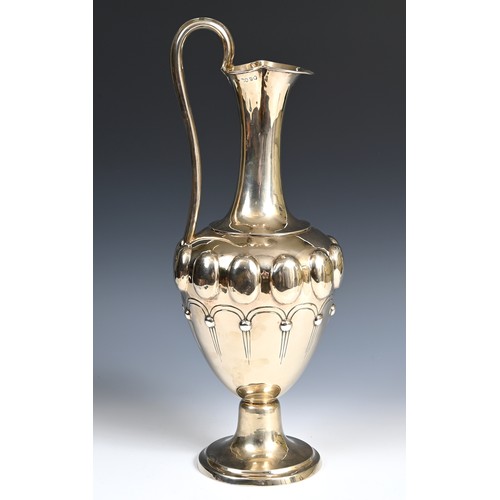 594 - A large Victorian silver gilt ewer, of vase form with embossed decoration, London 1857, 46.3 ozt, 62... 