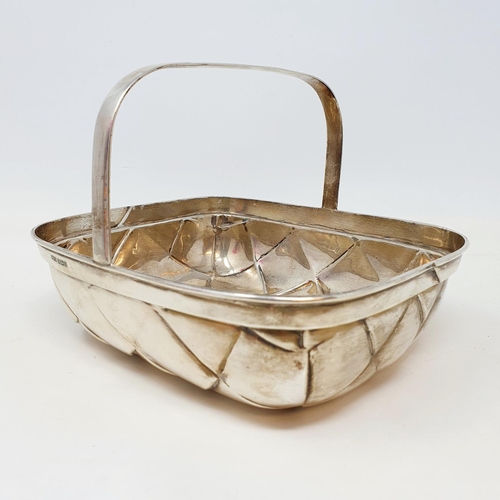 572 - An unusual silver basket in the form of a trug, with basket weave style decoration and a fixed handl... 