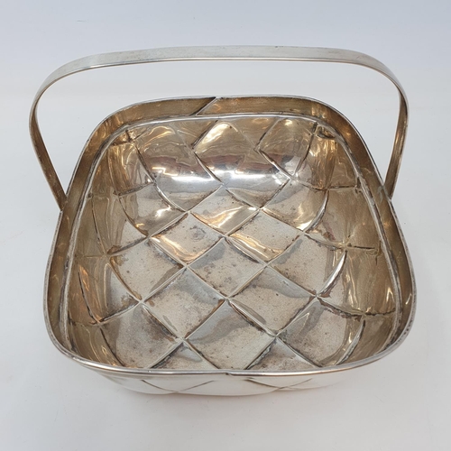 572 - An unusual silver basket in the form of a trug, with basket weave style decoration and a fixed handl... 