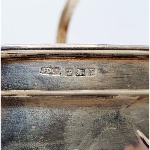 572 - An unusual silver basket in the form of a trug, with basket weave style decoration and a fixed handl... 