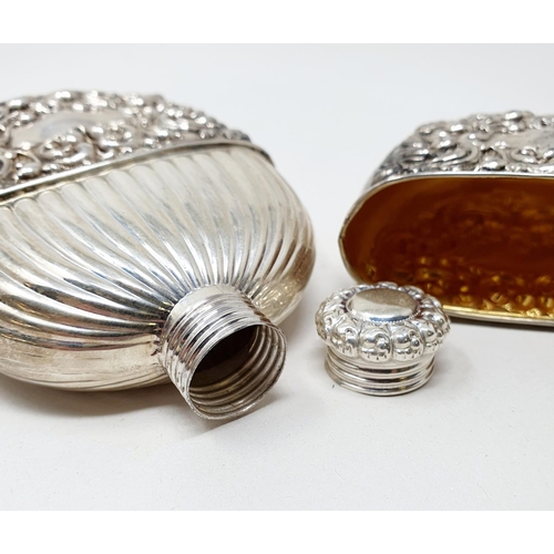 661 - A Sterling silver flask and cup, of oval form, embossed scrolling foliage, 2.6 ozt, 12 cm high