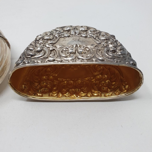 661 - A Sterling silver flask and cup, of oval form, embossed scrolling foliage, 2.6 ozt, 12 cm high