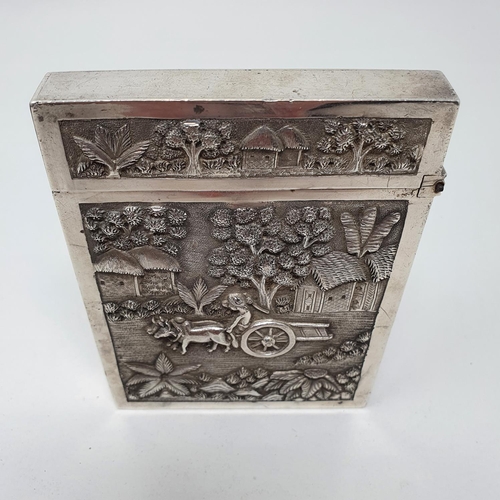 648 - An Indian silver coloured metal visiting card case, of good gauge, decorated a figure of a cart and ... 