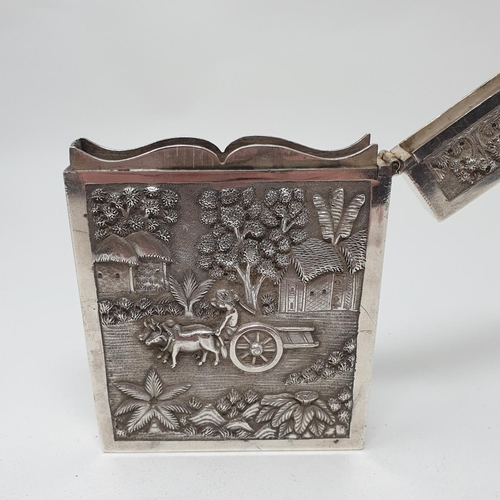 648 - An Indian silver coloured metal visiting card case, of good gauge, decorated a figure of a cart and ... 