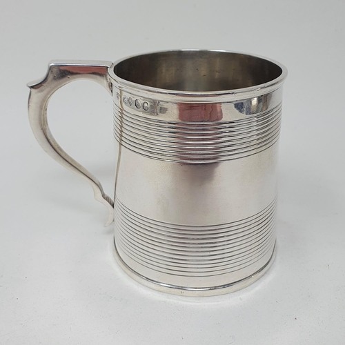 667 - An early 19th century silver mug, of tapering form, with reeded decoration, London 1823, 6.8 ozt, 8.... 