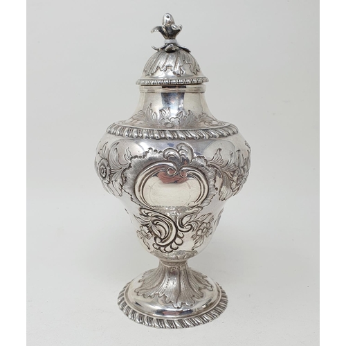 590 - A George III silver tea caddy and cover, of vase form, embossed a bird, flowers and foliage, London ... 