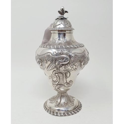 590 - A George III silver tea caddy and cover, of vase form, embossed a bird, flowers and foliage, London ... 