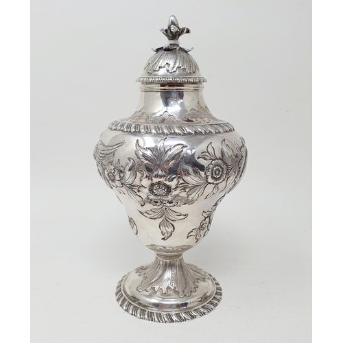 590 - A George III silver tea caddy and cover, of vase form, embossed a bird, flowers and foliage, London ... 