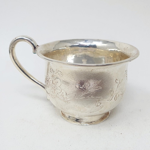 678 - A Chinese silver coloured metal cup or mug, decorated a bird and foliage, 6 cm high