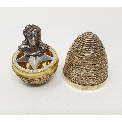 659 - A silver gilt surprise egg in the manner of Stuart Devlin, with textured decoration, London 1975/197... 