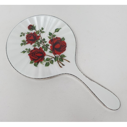 598 - A silver and enamel hand mirror, decorated roses, London 1959, 25.5 cm