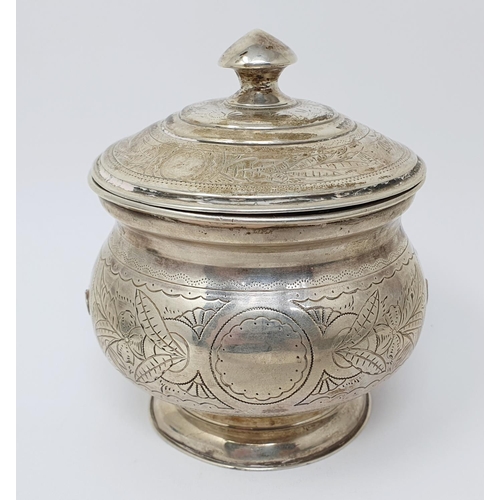 694 - A Russian silver jar and cover, of compressed circular form, and with engraved decoration, 84 mark, ... 