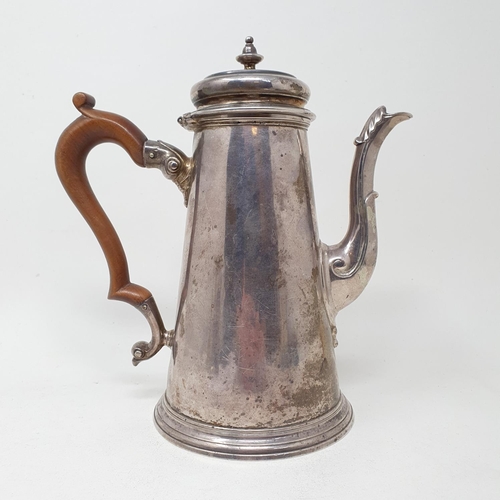 638 - A George II silver coffee pot, of tapering cylindrical form, the spout with an acanthus leaf, London... 