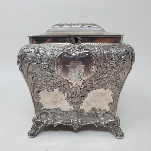 579 - A mid 19th century Scottish silver tea caddy, engraved an armorial, and embossed with flowers and fo... 