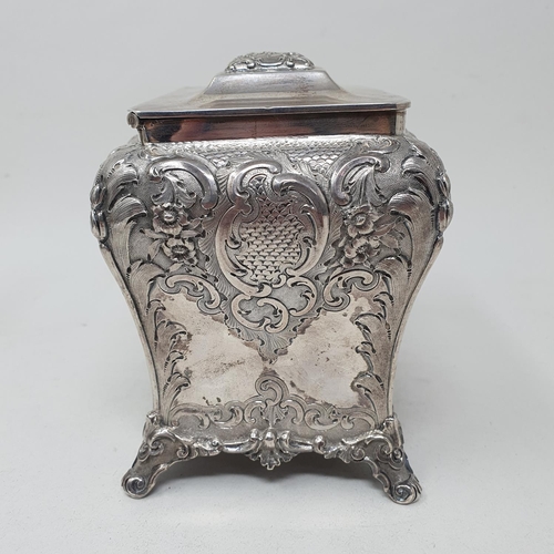 579 - A mid 19th century Scottish silver tea caddy, engraved an armorial, and embossed with flowers and fo... 