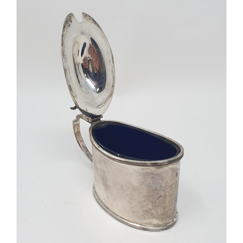 605 - A silver mustard pot, of oval form, Birmingham 1933, with a blue glass liner