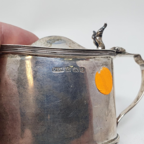 605 - A silver mustard pot, of oval form, Birmingham 1933, with a blue glass liner