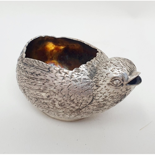 674 - A novelty silver coloured metal sauce boat, in the form of a chick, 5cm high