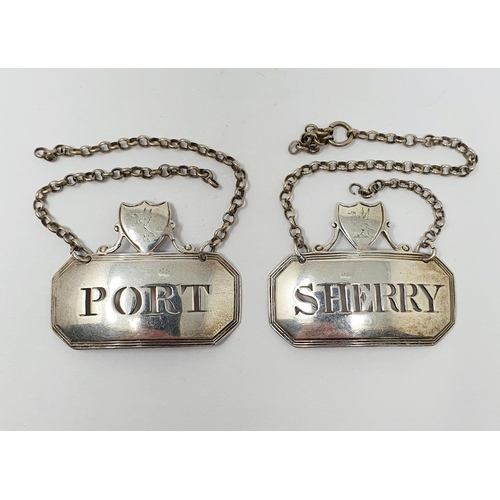 672 - An unusual pair of silver decanter labels, Sherry & Port, surmounted by cartouches which are crested... 