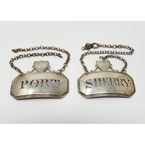 672 - An unusual pair of silver decanter labels, Sherry & Port, surmounted by cartouches which are crested... 