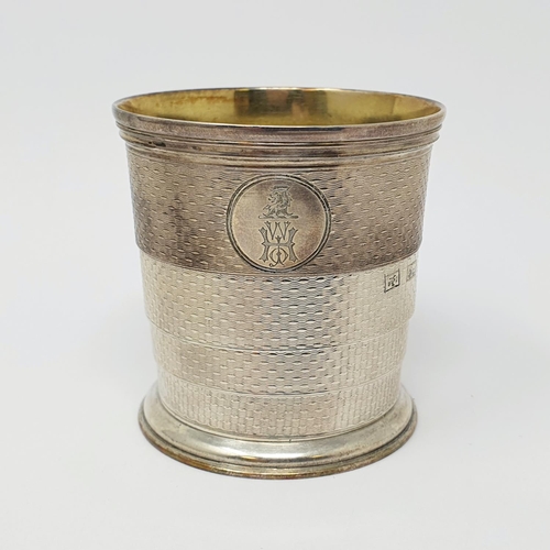 676 - A Victorian silver collapsible cup, crested and initialled, and with engine turned decoration, Londo... 