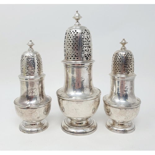 679 - A set of three George II silver casters, with pierced tops, the bodies of vase form, London 1731, 20... 