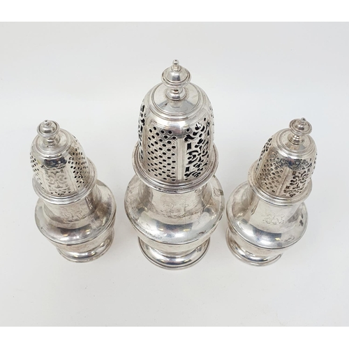 679 - A set of three George II silver casters, with pierced tops, the bodies of vase form, London 1731, 20... 