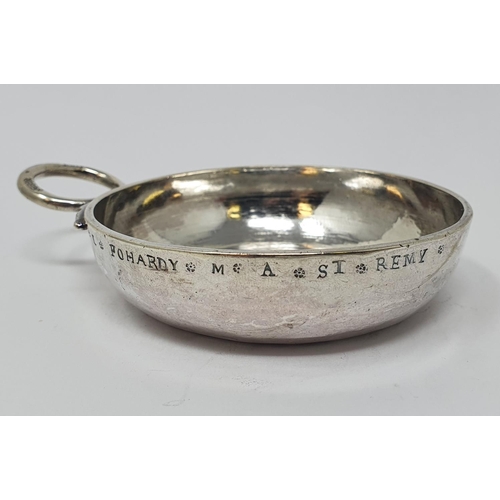 614 - An 18th century French silver wine taster, with a ring handle, 11 cm wide