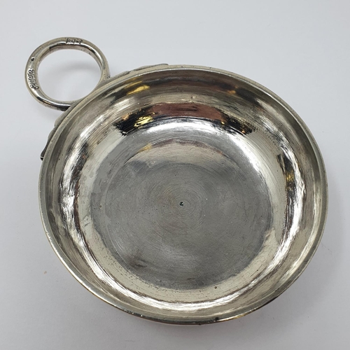 614 - An 18th century French silver wine taster, with a ring handle, 11 cm wide