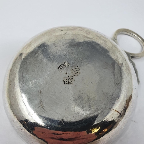 614 - An 18th century French silver wine taster, with a ring handle, 11 cm wide