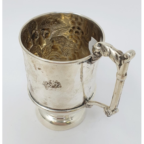 663 - A silver christening mug, decorated cherub face masks, chester 1911, 2.7 ozt, 10.5 cm high