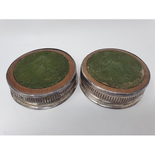 577 - A pair of early 19th century silver wine coasters, with reeded lower bodies, marks indistinct (2)