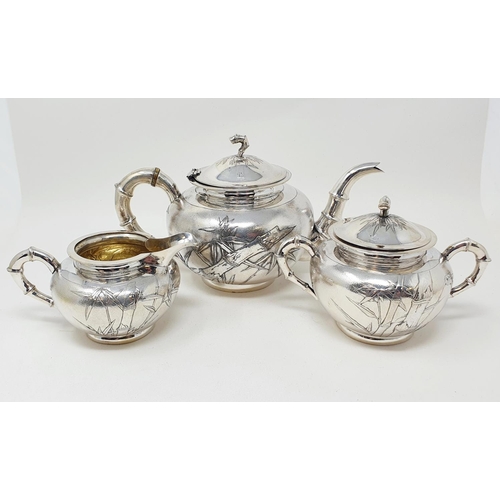 645 - A Chinese silver coloured metal three piece tea set, monogramed and decorated bamboo, comprising a t... 