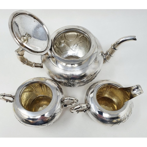 645 - A Chinese silver coloured metal three piece tea set, monogramed and decorated bamboo, comprising a t... 