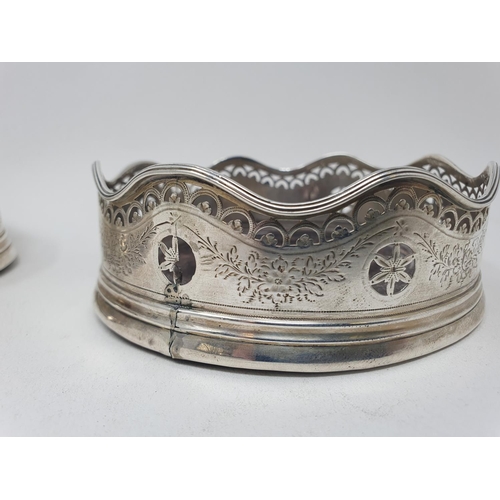 593 - A pair of early 19th century silver coasters, with a wavy rim, with pierced and engraved decoration,... 