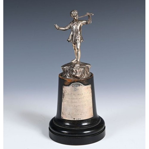 586 - A cast silver figure, of Peter Pan, 11.5 cm high, London 1949, on an ebonised base, with a sliver pl... 