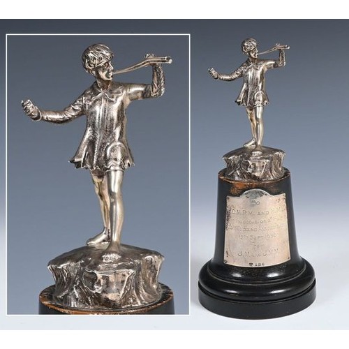 586 - A cast silver figure, of Peter Pan, 11.5 cm high, London 1949, on an ebonised base, with a sliver pl... 