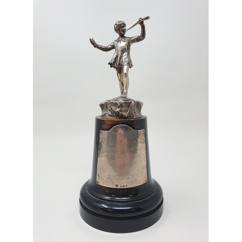 586 - A cast silver figure, of Peter Pan, 11.5 cm high, London 1949, on an ebonised base, with a sliver pl... 