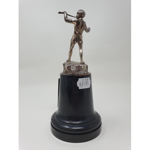 586 - A cast silver figure, of Peter Pan, 11.5 cm high, London 1949, on an ebonised base, with a sliver pl... 