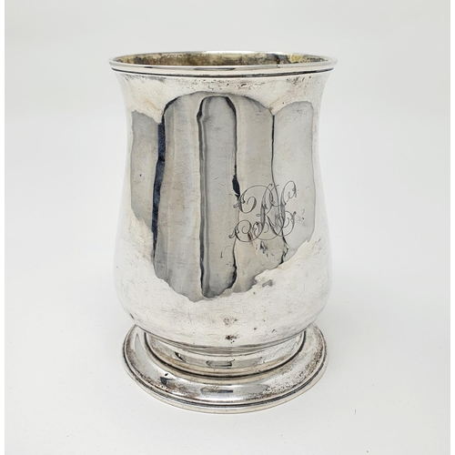 693 - A George III silver mug top of baluster form, with a leaf capped scroll handle, London 1770, 10.0 oz... 