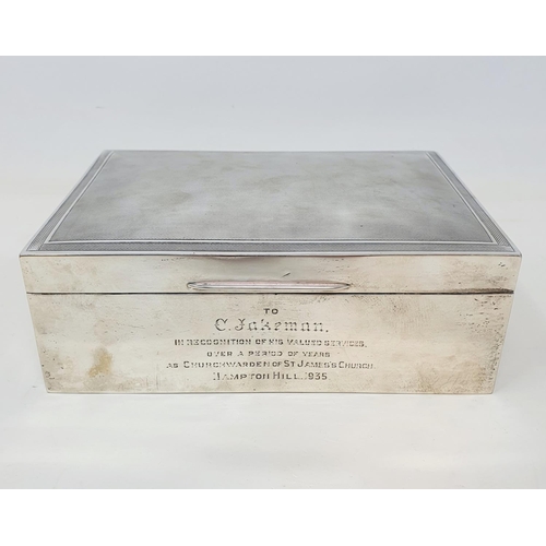 576 - A large table cigarette box, the lid with engine turned decoration, the front with a presentation in... 