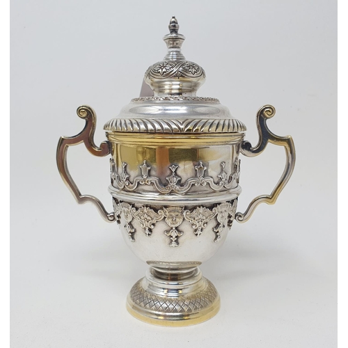 601 - A silver cup and cover, decorated face masks and strapwork , Sheffield 1931, 9.2 ozt, 15 cm high