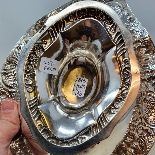 408 - A Victorian silver oval bowl, raised on a foot, with floral decoration, Chester 1895, 14.4 ozt  Prov... 