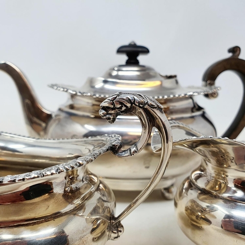 410 - An Edward VII three piece silver tea service, the teapot with wooden handles, Birmingham 1908, all i... 